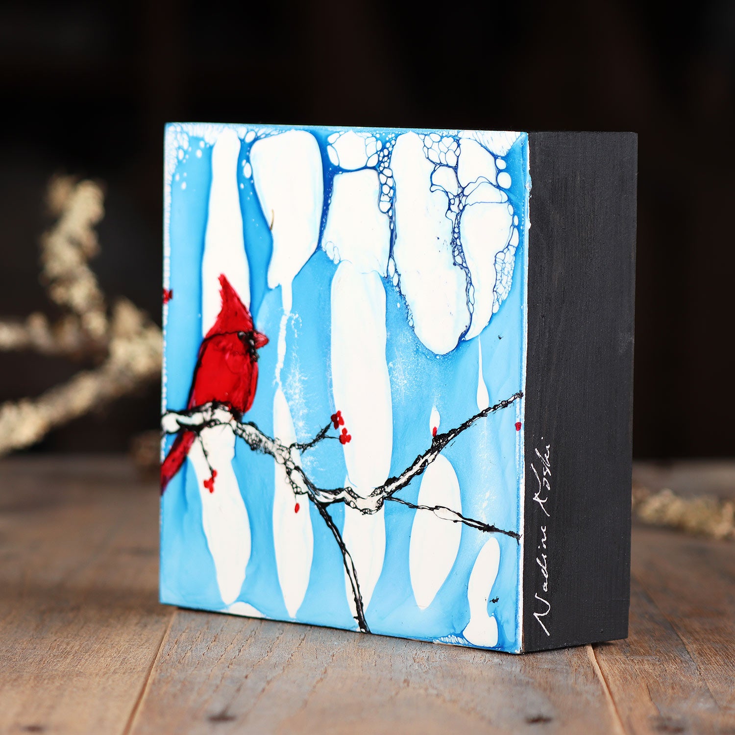 Cardinal and Berries On A Snowy Blue Background