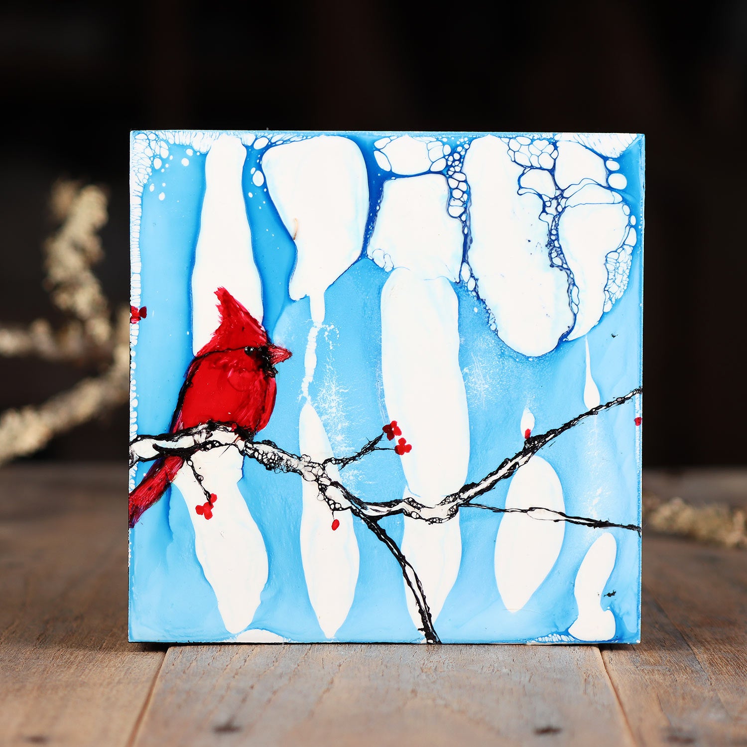 Cardinal and Berries On A Snowy Blue Background